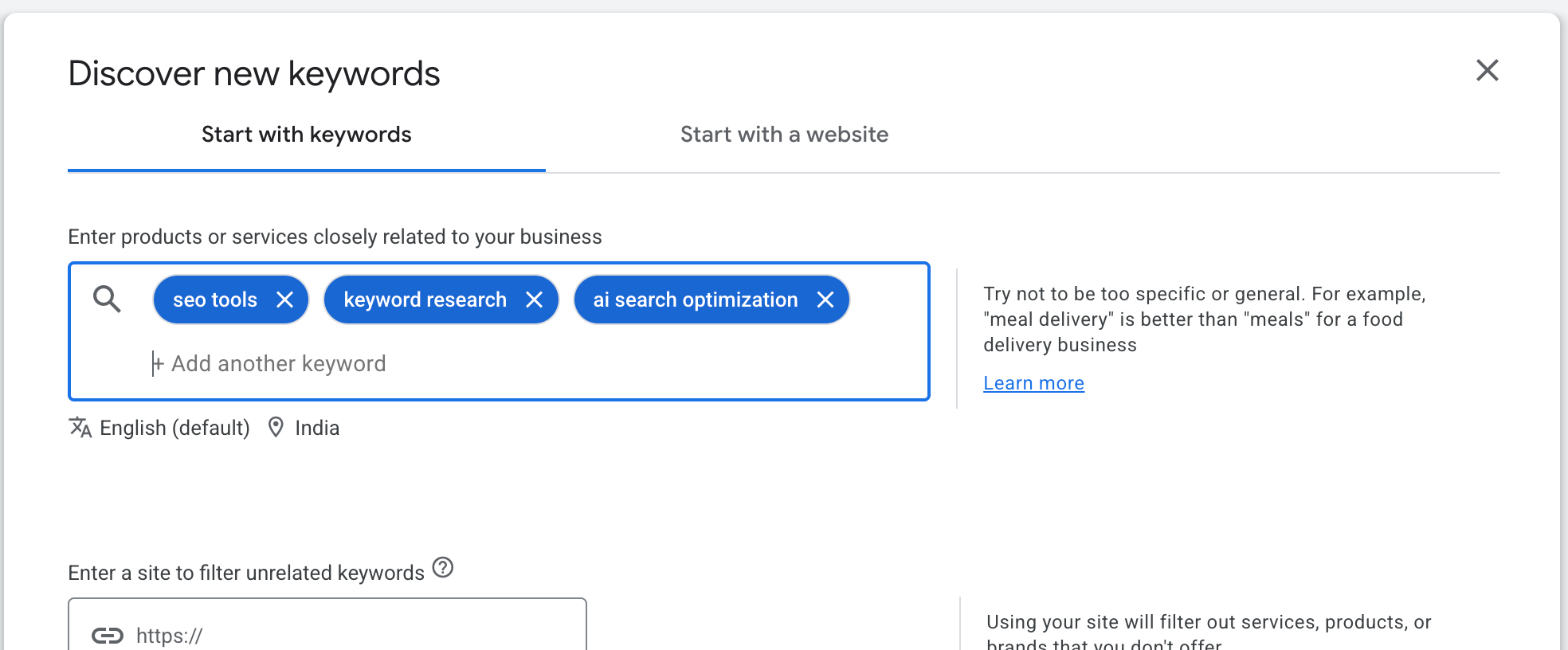 The Discover new keywords box with three seed terms entered: seo tools, keyword research, ai search optimization, with English and India selected underneath